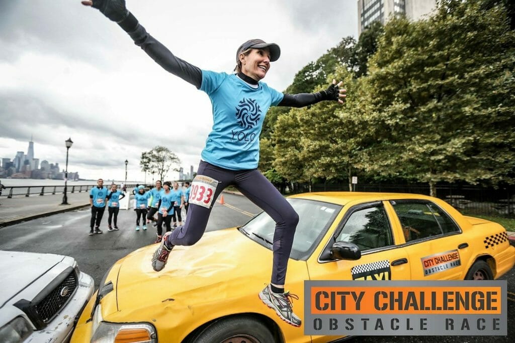 Danielle Taylor jumps over a taxi as part of the City Challenge obstacle course race for charity in Hoboken, N.J., in October 2018./Courtesy Danielle Taylor