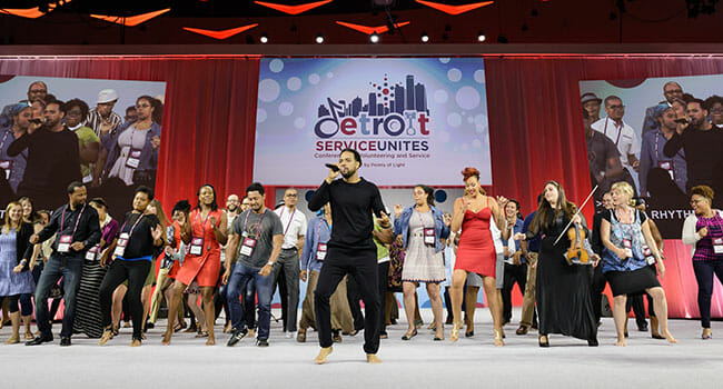 “As changemakers, we have been charged to live our passion out loud, with enthusiasm,” said emcee Mike Ellison, who invited attendees on stage to participate in his final performance at Conference.