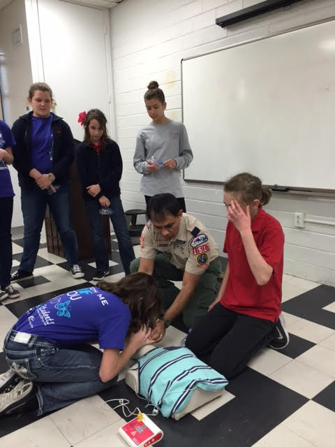 Benjamin Agleam teaching teens lifesaving CPR techniques.