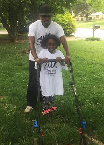 Rodney Smith helps a young volunteer.