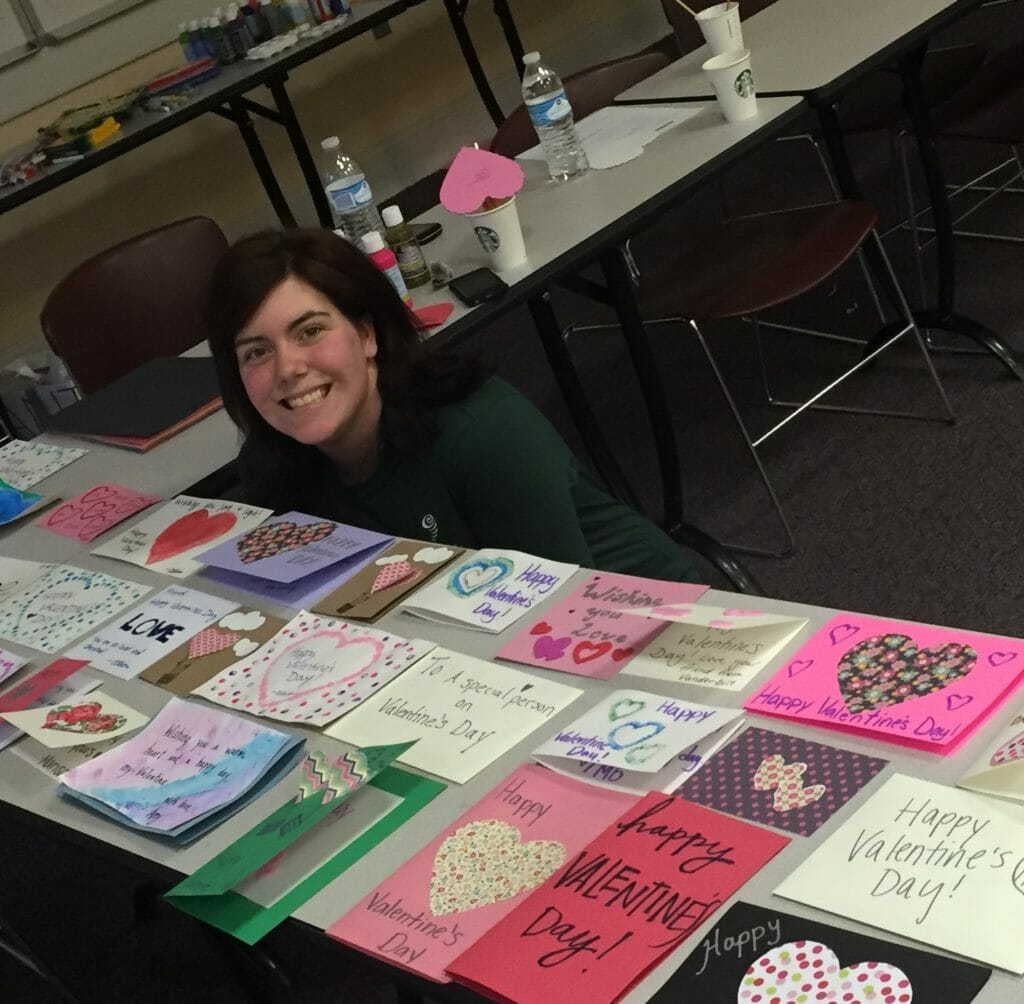 Allison Plattsmier pictured with Valentine's Day cards she helped create for Meals on Wheels recipients.
