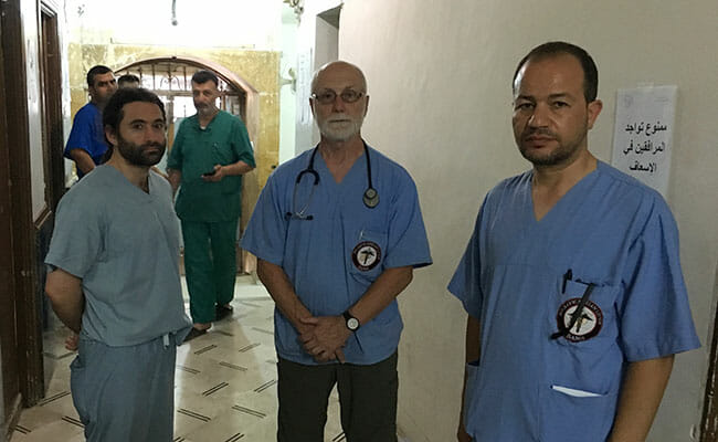 Samer Attar, John Kahler and Zaher Sahloul at a hospital visiting a fellow doctor who had been killed in a Russian airstrike.