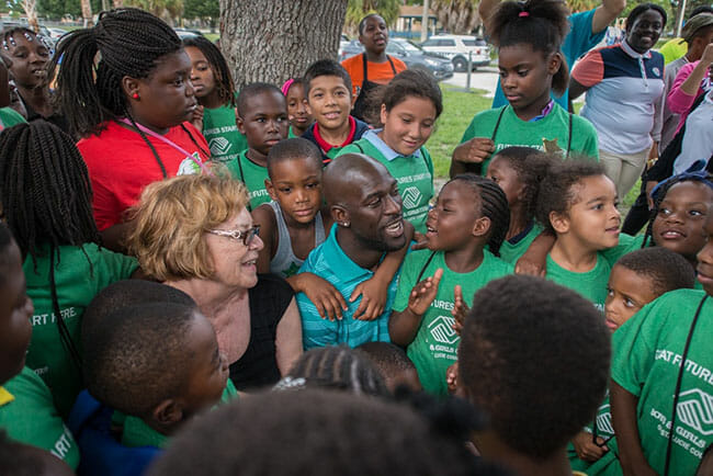 Michael Thomas volunteers with local children through the Boys and Girls Club.