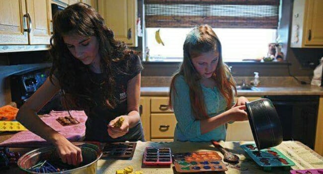 Abby and Riley Neff make crayons in their kitchen.