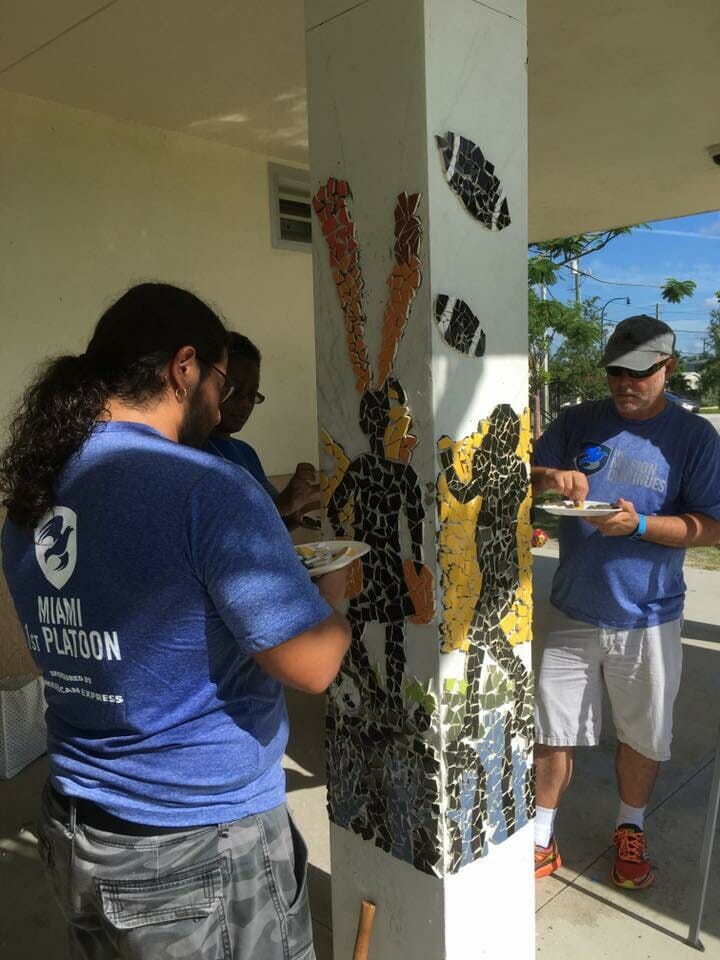 Edwin (left) and his fellow volunteers work on an ongoing mosiac project at Norland Middle School./Courtesy Edwin Vasco