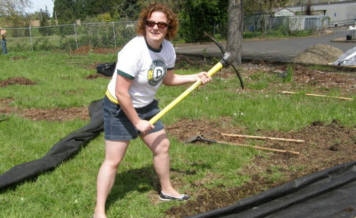 Morgan Levey, as an AmeriCorps VISTA, helping to build a playground at a community garden with Arc.