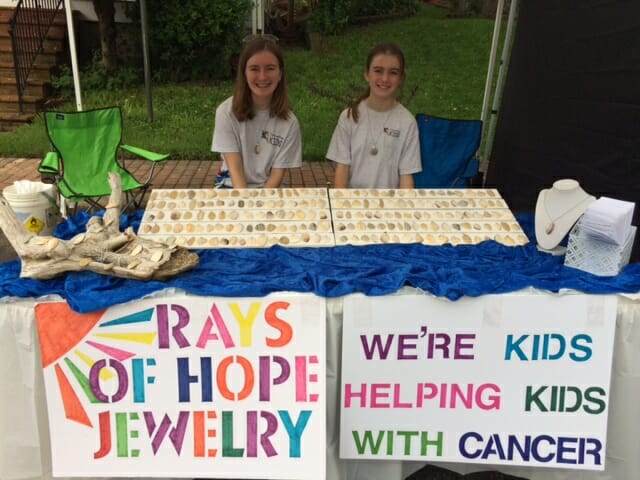 Jenna and Cara Ainge selling their necklaces at a craft fair./Courtesy Dennis Ainge  