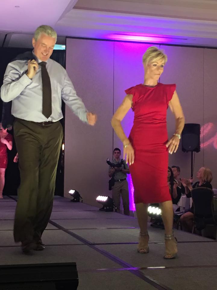 Maureen Walsh on stage with her husband, Chuck, during a fashion show at the Great Guys Dinner in 2017 at Springfield Country Club.