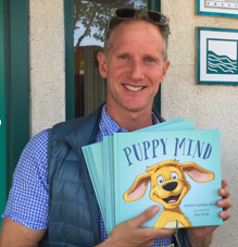 Andrew Nance with his book Puppy Mind, which he uses to instruct students in mindfulness classes./Courtesy Andrew Nance