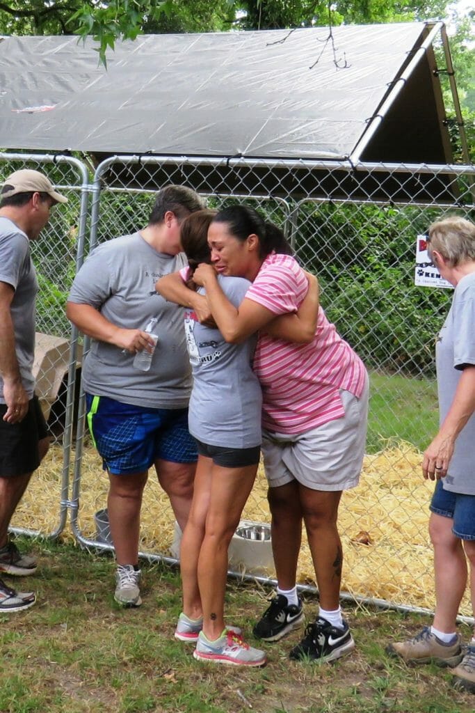 Sylvia receives a hug from a pet owner with multiple sclerosis who had been financially unable to provide a kennel for her dog, Cole. BTCKK also provided the owner with groceries and birthday presents for her nine-year-old son./Courtesy Sylvia Mayon