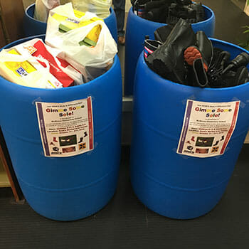 Donation bins at Azad's Martial Arts Center, where students and community members could drop off new or gently used shoes and rain boots during the month-long donation drive.