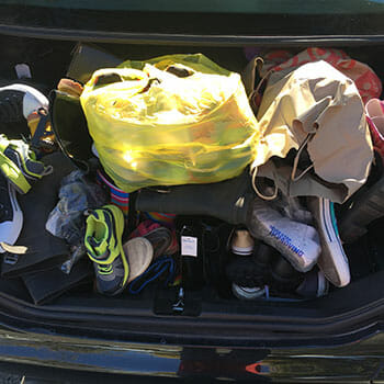 Farshad's car overflowed with shoes and boots collected through "Gimme Some Sole."