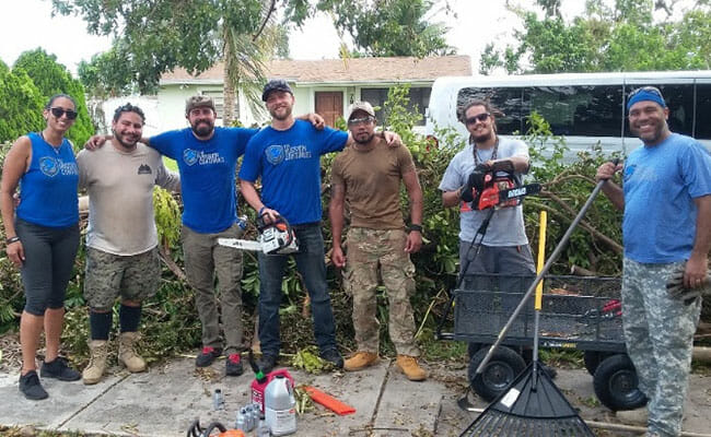 Derek Auguste (far right) and members of the Miami Service Platoon he leads through The Mission Continues helped clear debris from area homes after Hurricane Irma. 