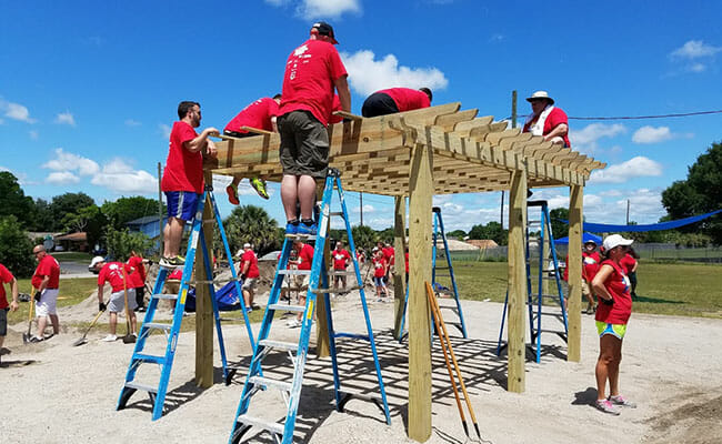 Hands On Orlando volunteers work together to build a structure at a local park.