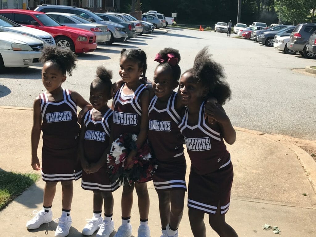 Chioma's cheerleading students pictured in their game uniforms./Courtesy Chioma Ajuonuma