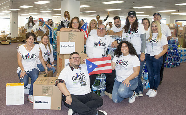 Rafael Babilonia, center, and Unidos por Puerto Rico - DMV volunteers work tirelessly to collect supplies to be delivered to the people of Puerto Rico who have been impacted by recent, devastating hurricanes.