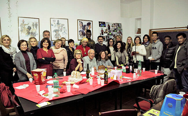 Volunteers gather for a Christmas party at Casa Africa, an organization dedicated to helping immigrants assimilate to life in Rome. Recruited by RomAltruista, volunteers teach newcomers to read and speak Italian so they can find employment.