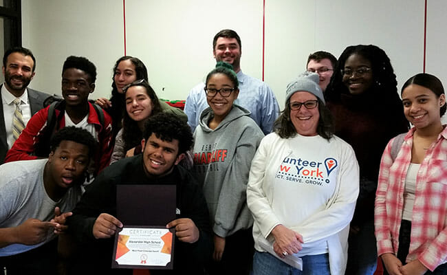 High school students show off their certificate of achievement after raising food donations for the needy during the Un-Hunger Games competition, run by the Volunteer New York! Hunger Relief Corps.