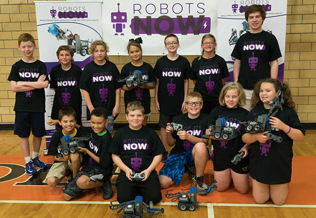 Chandler Wimmer (back-left) and Gabriel Wimmer (back-right) with participants at their RobotsNOW summer camp in Bristol, Va.
