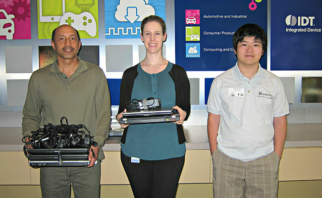 Terence Lee (right) receives surplus laptops from Integrated Device Technology Inc., a local EqOpTech partner, as part of IDT’s Acts of Giving campaign in May 2017.