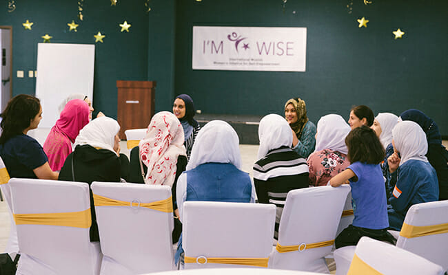 Women gather together at an (IM)WISE training.