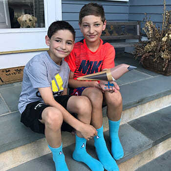Matty and Will Gladstone, wearing the Blue Feet Foundation's signature blue socks.
