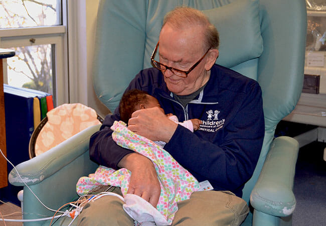 Known as “ICU Grandpa,” David snuggles ICU babies, offering them extra warmth, comfort and love.