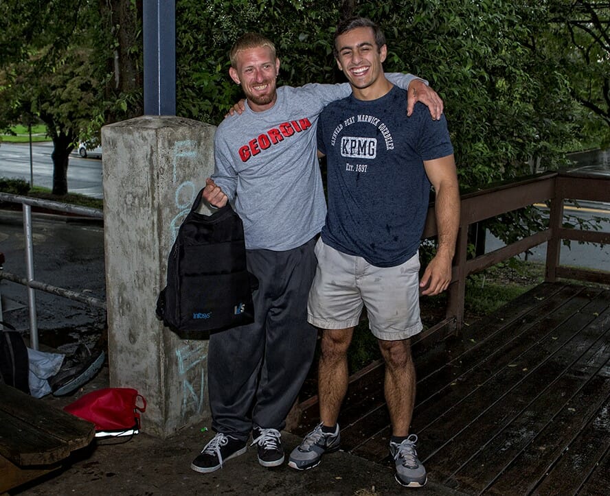 Zack Leitz and a homeless man share a quick embrace after giving him a backpack and chatting./Courtesy Zack Leitz