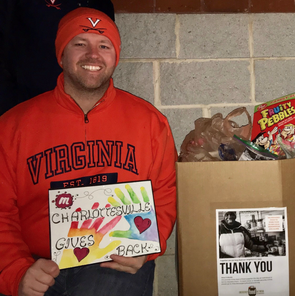 Christopher Mastromarino with a box of food collected for the Charlottesville Emergency Food Network. Over 70 bags of groceries for families in need were collected during the annual event./Courtesy Christopher Mastromarino