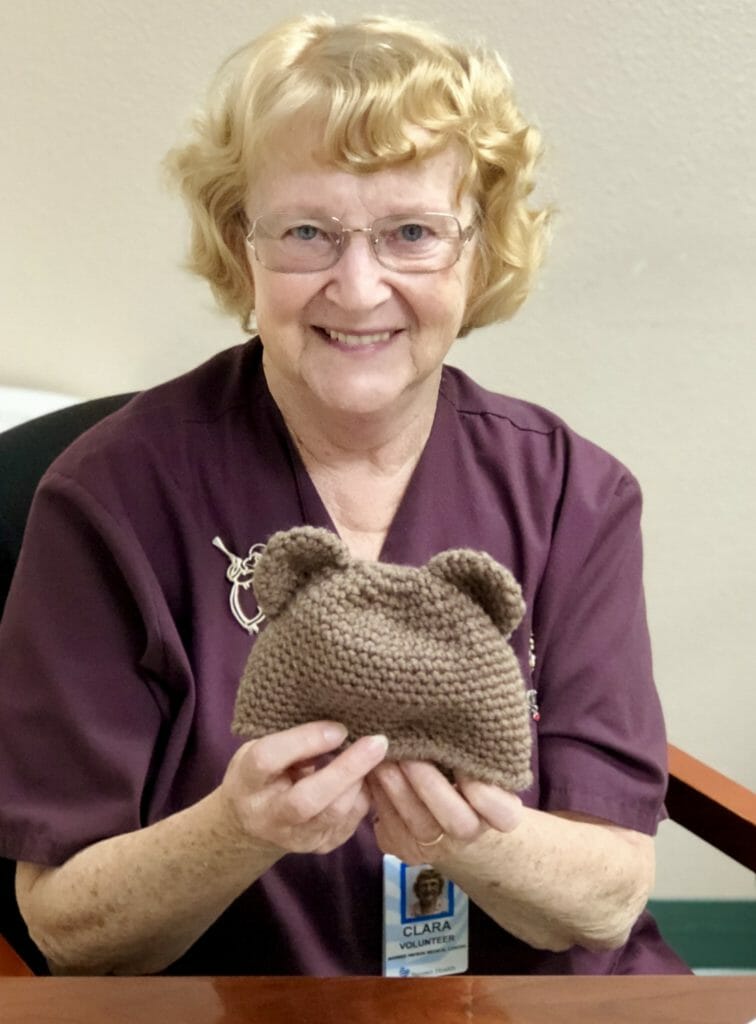 Clara with one of the hats she knits for newborns at the hospital./ Courtesy Banner Payson Medical Center
