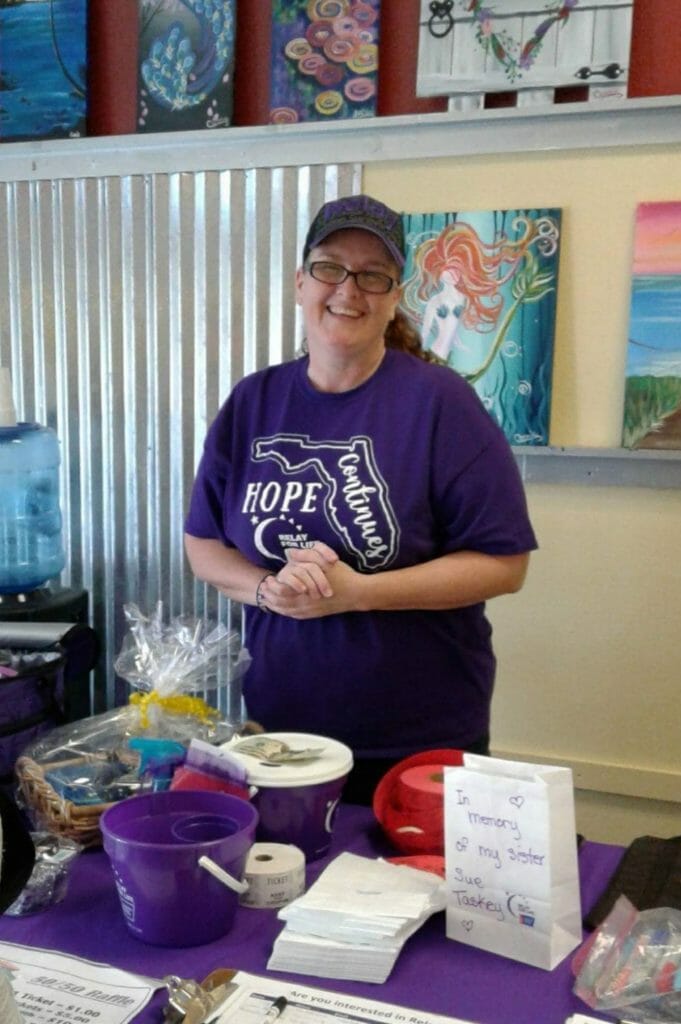 Maryanne Bolduc working the information and raffle table at the Painting with a Purpose fundraiser./coutesy Maryanne Bolduc