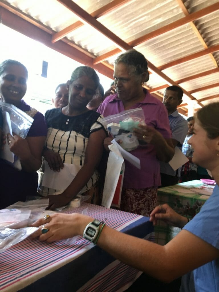 Mai Griffith handing out first aid kits in an isolated village in Sri Lanka this past July, the first aid kits were made from donations received throughout the year and assembled at an event put together by Western Digital for Hearts for Hearts Foundation./Courtesy Mai Griffith