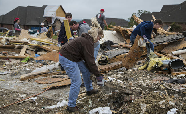 Team Rubicon volunteers remove debris from a home in Mayflower, Arizona, that was destroyed by a tornado. // Photo Credit: FEMA. 