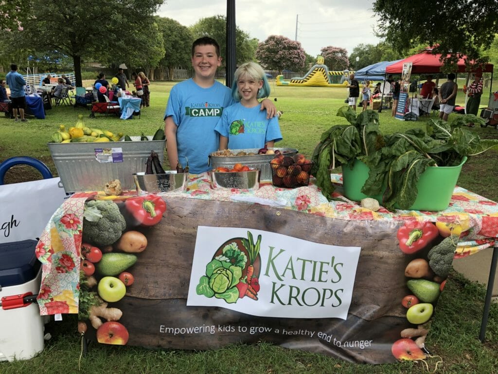 Ian and his sister, Addison, at local "Pop-up Farmers Market" where they distribute the produce they grow in their gardens. Ian chooses locations in food deserts or is invited by hunger relief organizations to distribute along with their mobile food pantry./ Courtesy Ian McKenna 