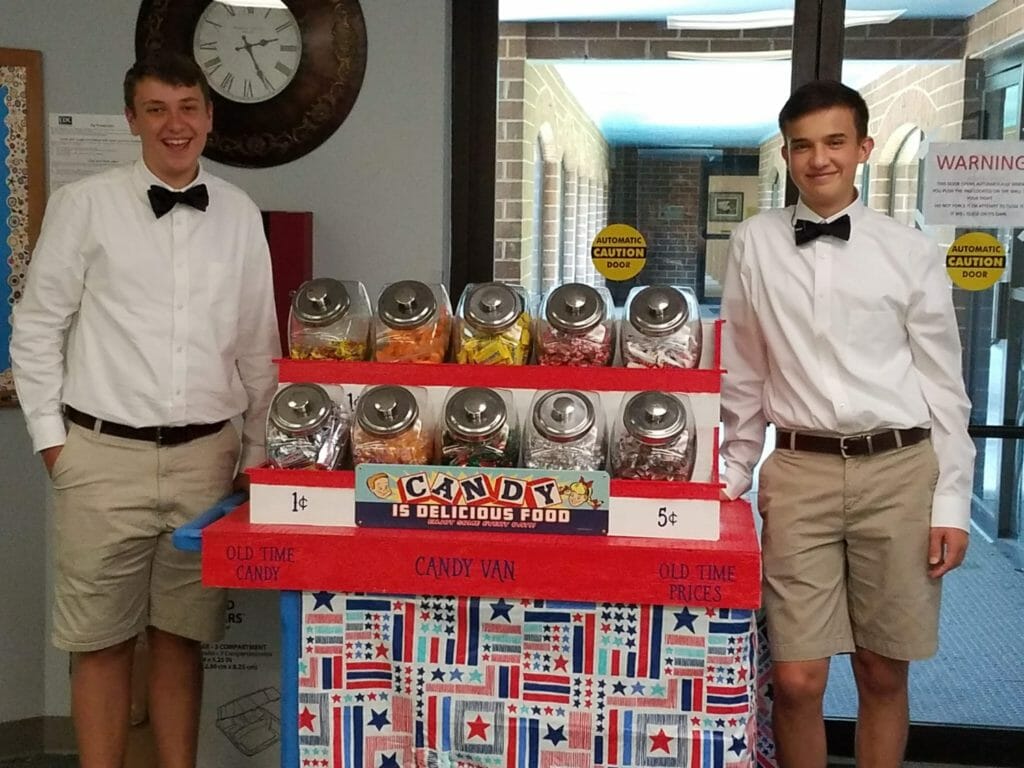 Ben Trofemuk (left) and his friend in front of their candy cart, which they use to sell old-fashioned candy to senior citizens living in nursing homes./ Courtesy Ben Trofemuk 