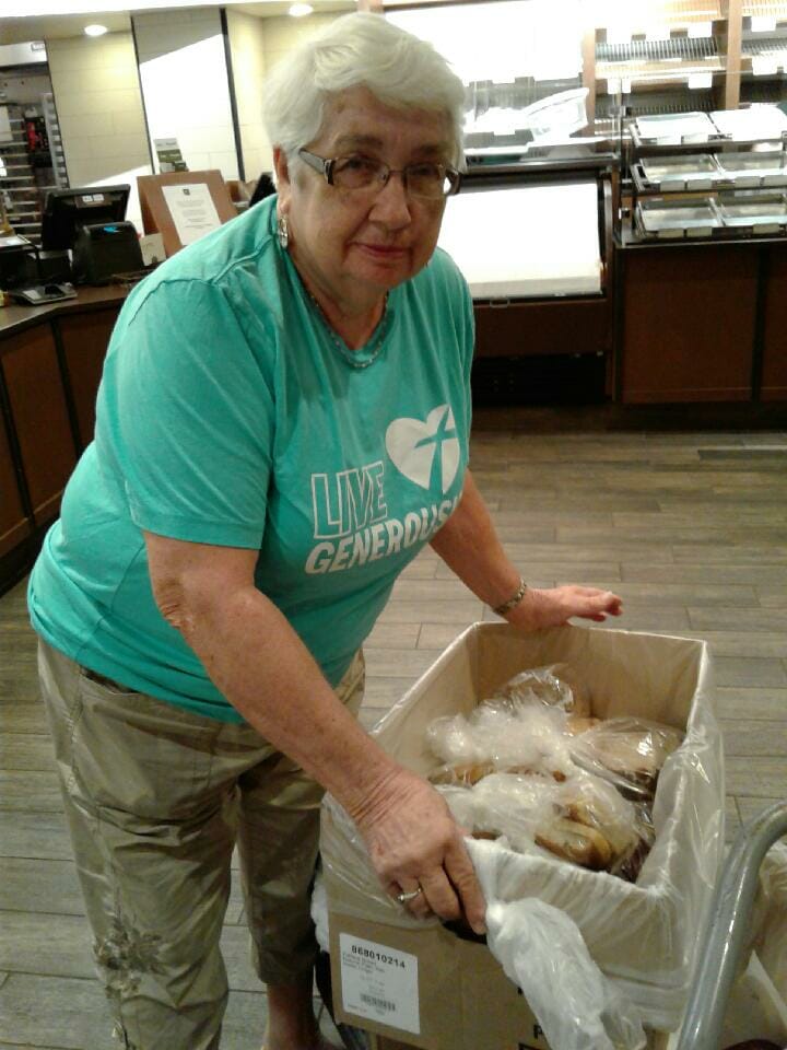 Bonnie Clark pictured with unsold bread and baked goods that her community Panera donates to local hunger relief and charitable organizations./ Courtesy Bonnie Clark