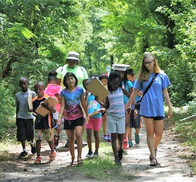 Brittany Turner (far right)  leads a group of children attending Love a Sea Turtle summer camp on a nutrition scavenger hunt./ Brittany Turner