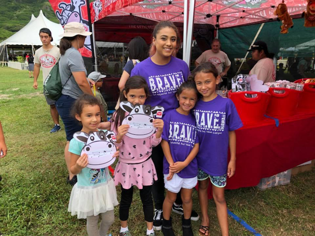 Mahealani (center) volunteering with B.R.A.V.E. Hawai’i sponsor Meadow Gold at the Farm Fair at Kualoa Ranch./ Courtesy Mahealani Sims-Tulba