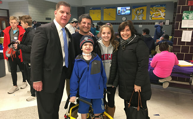 The Elwy Family with Mayor Marty Walsh (left) at Boston Cares’ 2018 MLK Day of Service event, where the family made flashcards for immigrants preparing to take their citizenship test. 
