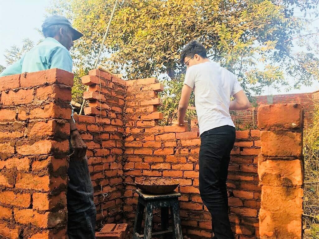 Ansh helps construct a village’s first public toilet in December 2016./ Courtesy Ansh Jain
