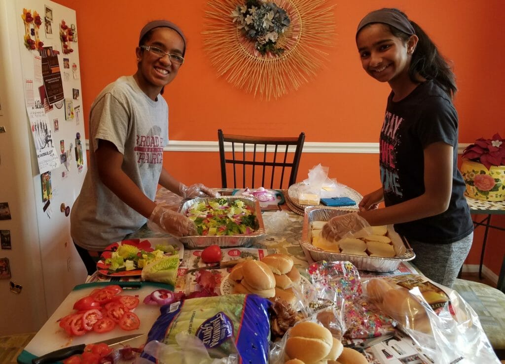 Shreyaa (left) and Esha (right) making burgers for the homeless at the Loudoun Homeless Services Center, Leesburg VA./ Courtesy Shreyaa & Esha Venkat