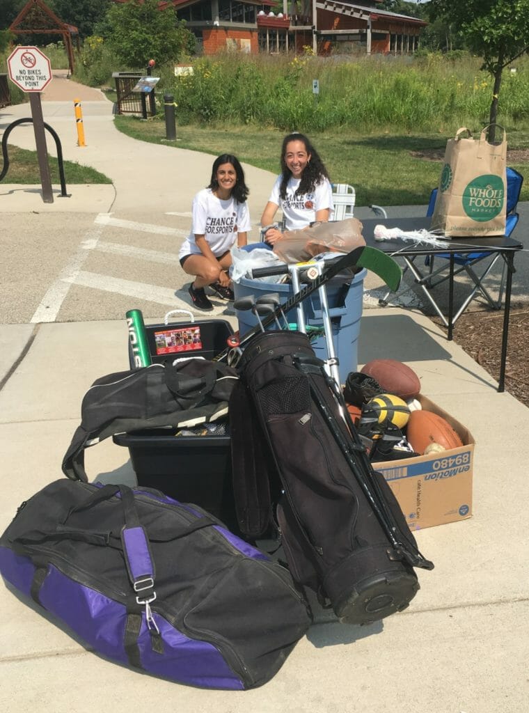 Anuva pictured with her board member, Tala Fahoum, alongside sports equipment donations received during a 2018 summer fundraiser./ Courtesy Anuva Shandilya