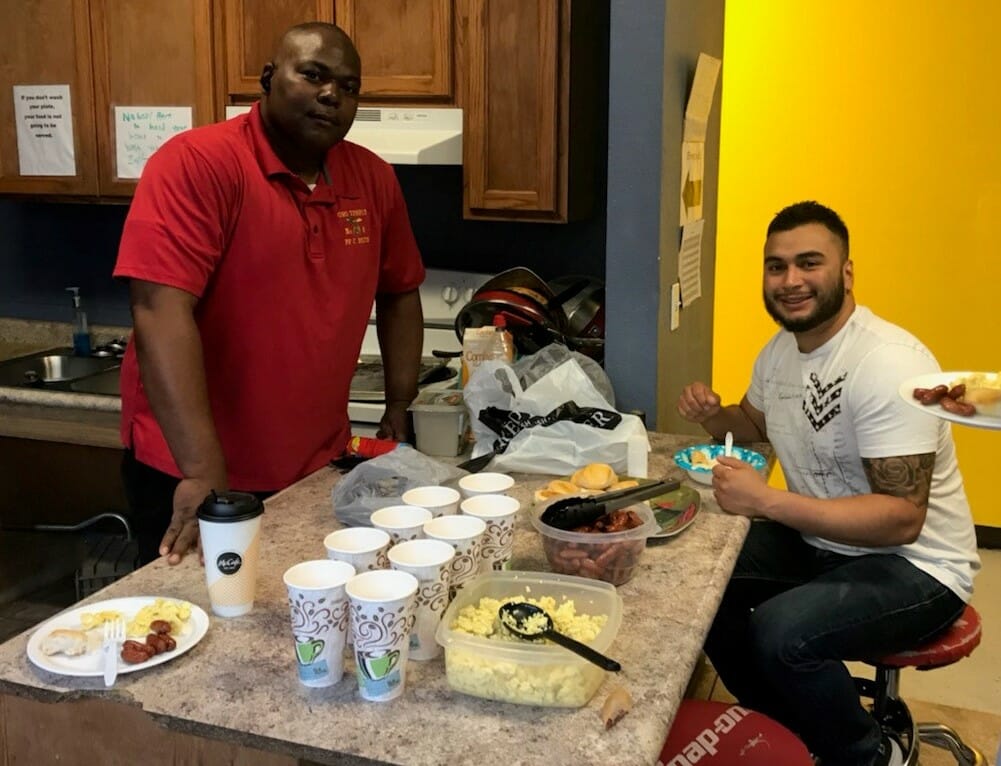 Curtis Smith (Left) at breakfast at the El Paso Winchester House with employees./Courtesy Curtis Smith