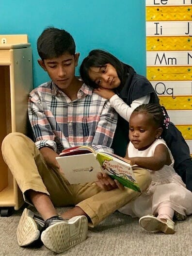 Neil reads to children at the Crescent Learning Center, where he volunteers with predominantly refugees./Courtesy Neil Sai Dogra