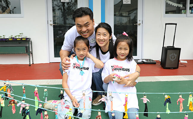 A family of four participates in HandsOn Hong Kong's 2018 Family Volunteer Day project, upcycling unwanted materials into donated items for community centers.  