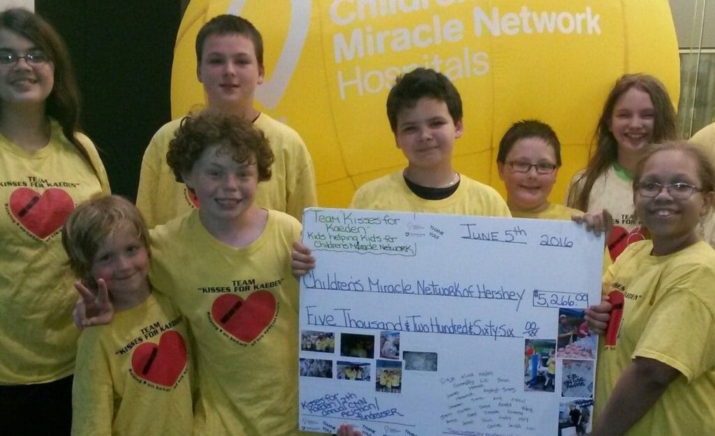 Kaeden (third from left) and Team Kisses for Kaeden after a fundraiser for the Children’s Miracle Network of Hershey./Courtesy Kaedan James Rhodes
