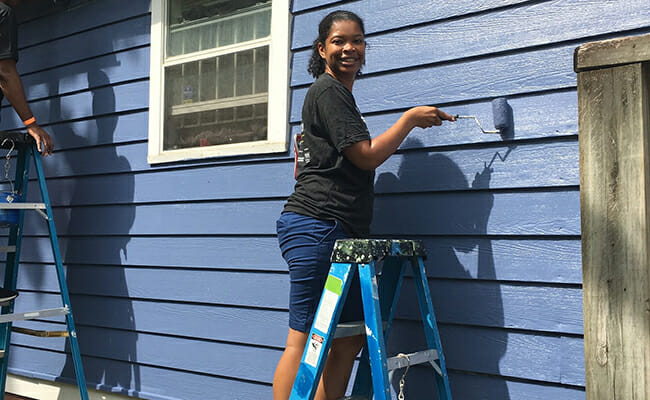 Martina Edwards participates in a home painting project with Westside Volunteer Corp in Atlanta.