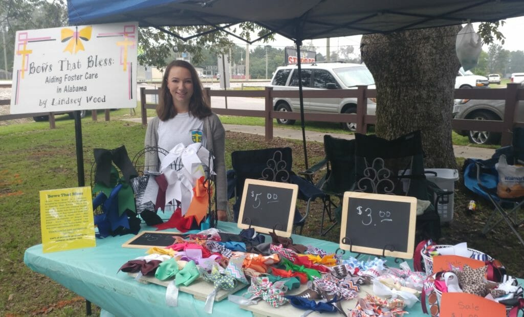 Lindsey Wood selling hair bows at a festival for through Bows That Bless, which benefits children living in foster care./Courtesy Lindsey Wood
