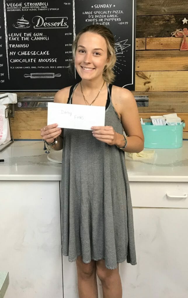 Darby Campbell holding a check received at a fundraising event./Courtesy Darby Campbell