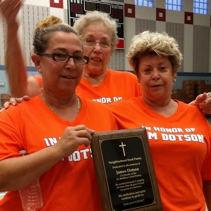 Jo Chesser (Left) shows off a plaque honoring her dad Jim Dotson, co-founder of the food bank that she continues in his honor./Courtesy Jo Chesser